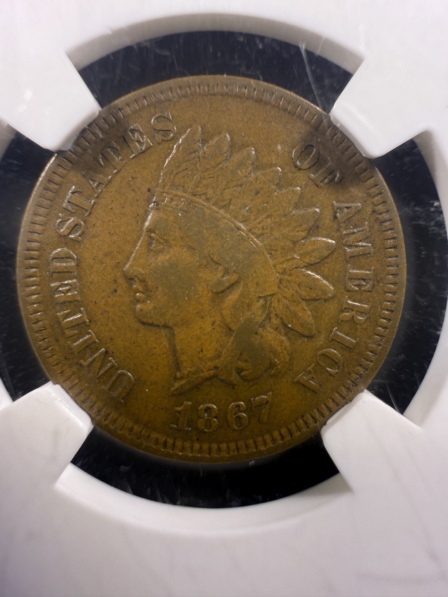 1867 Indian Head penny die cud error showing raised blob of metal at the rim from a broken die